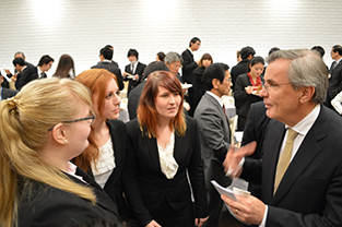 Exchange students interact with Ambassador Vargö during the reception