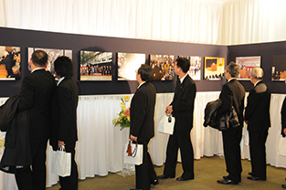 Guests viewing the photo display panel showing scenes from the Honorary Chancellor’s life