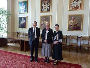 Joanna Nagłowska  (C) of the International Exchange Center,  Professor Ichiyama (R), Director Namikama (L) in a room lined by portraits of past University of Warsaw presidents