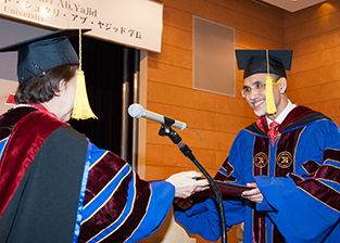 President Shukri (R) accepts his honorary doctoral degree