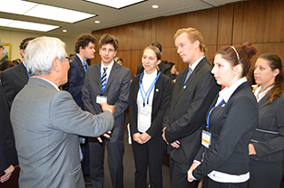 Exchange students interact with Commissioner Mr. Aoyagi during the reception