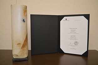 Cikada Prize certificate and trophy