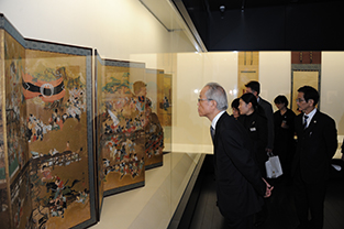 Dr. Kobayashi gazes upon the pieces at the Mizuta Museum of Art