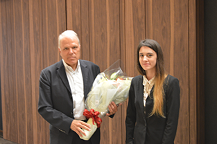A bouquet was presented to Mr. Eklund by an exchange student