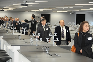 Participants tour a laboratory at the new building for the Faculty of Pharmaceutical Sciences