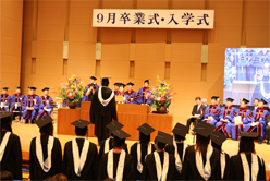 Graduates receiving diplomas from Chancellor Noriko Mizuta