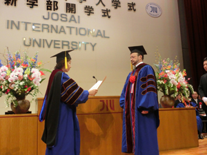 Chancellor Mizuta giving an honorary doctorate to Dr. Louis Lemkow