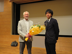 Professor Lamarre receiving a bouquet from a student